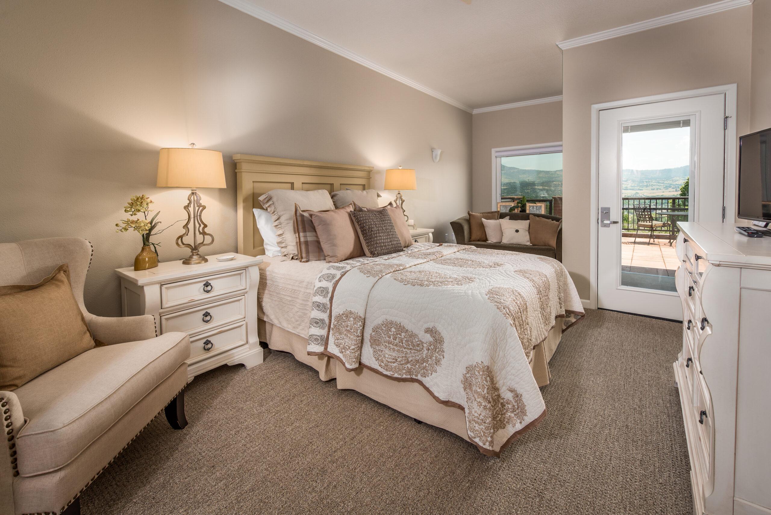 Photo of a bedroom with an attached deck in a Rogue Valley Manor residence.