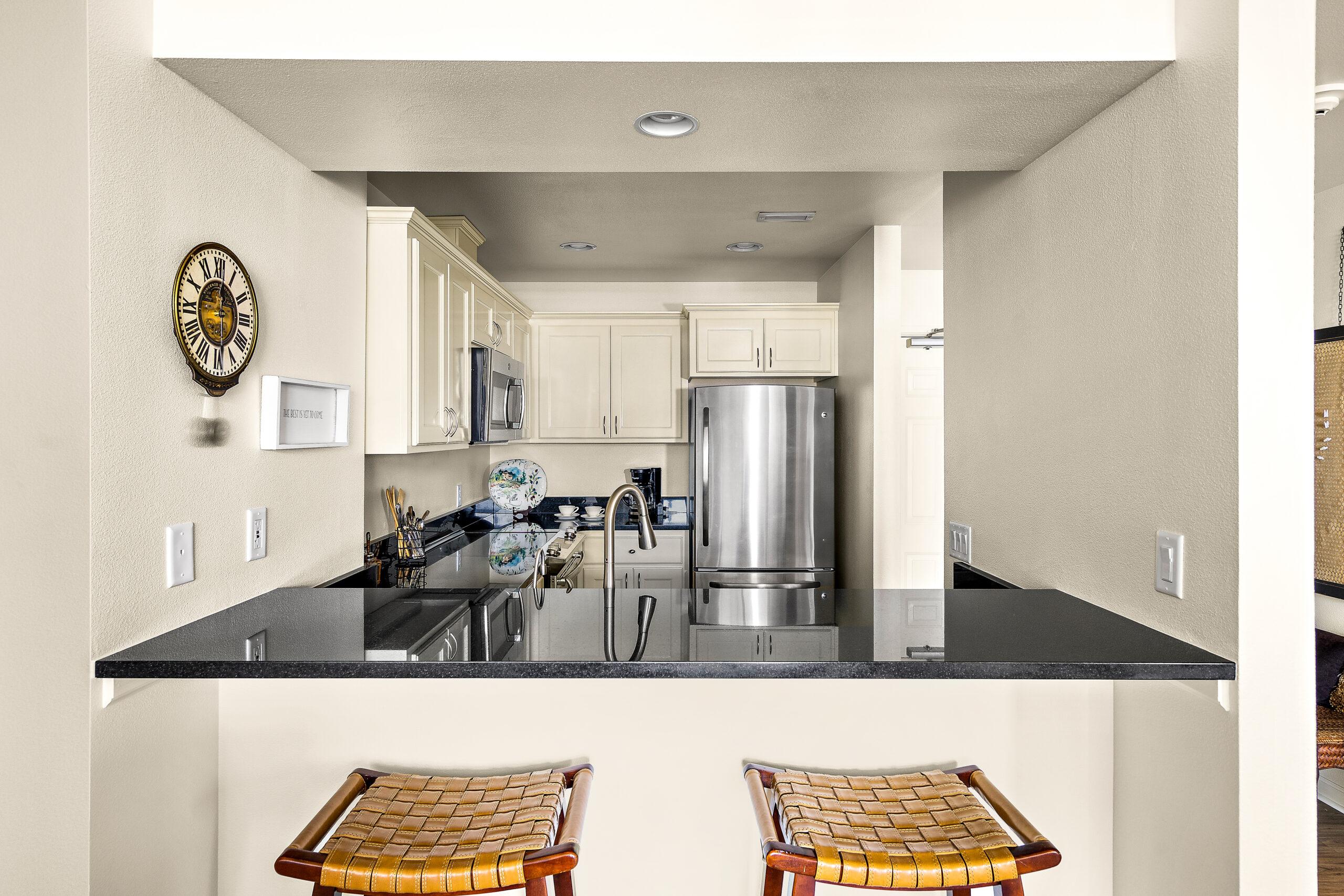 A kitchen area with breakfast bar seating in a Rogue Valley Manor residence.