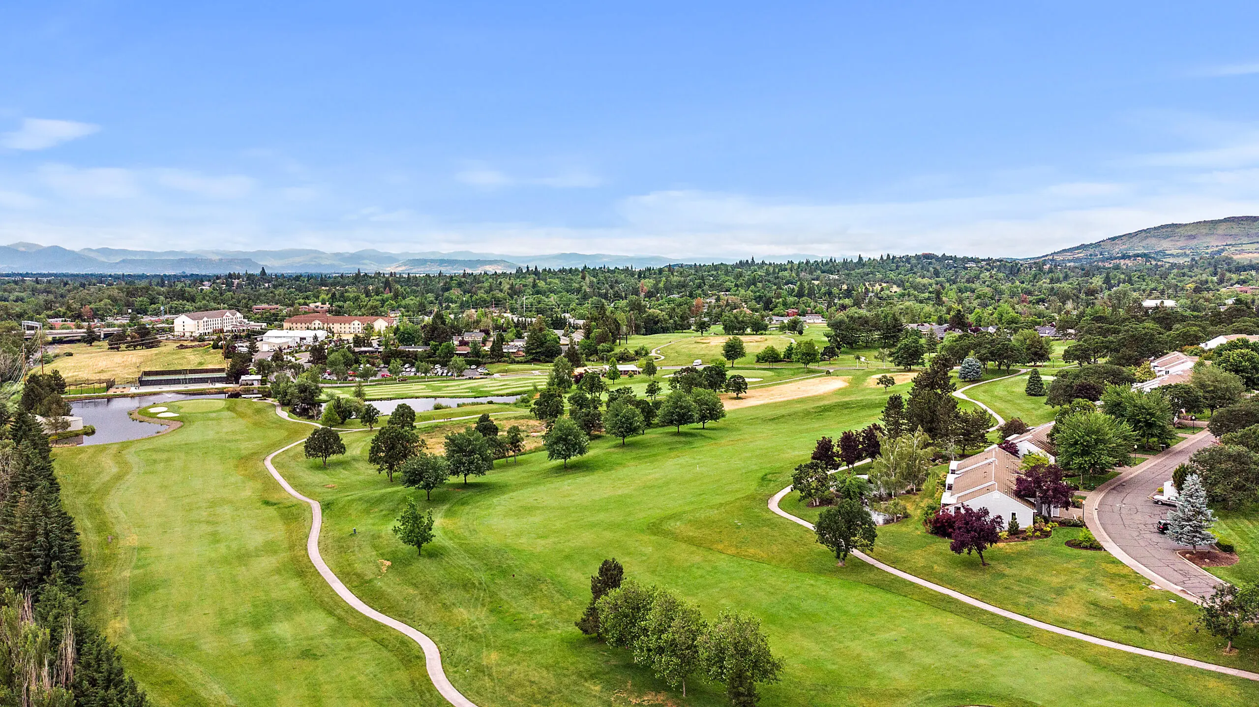 Aerial view of the Rogue Valley Manor area, showing lots of trees and a walking path.