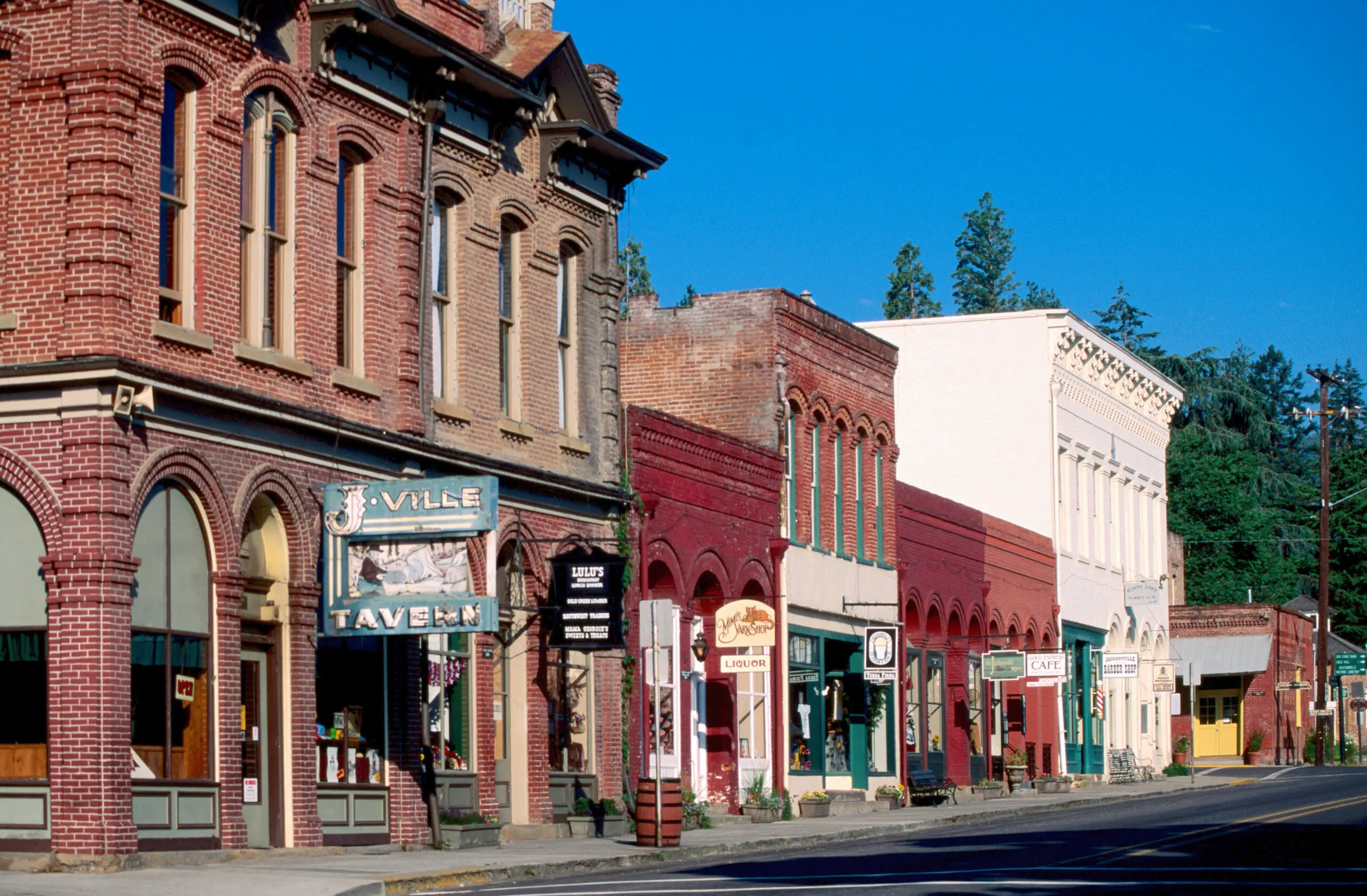 Historic California Street. The photo depicts several brick buildings with signs hanging in front.