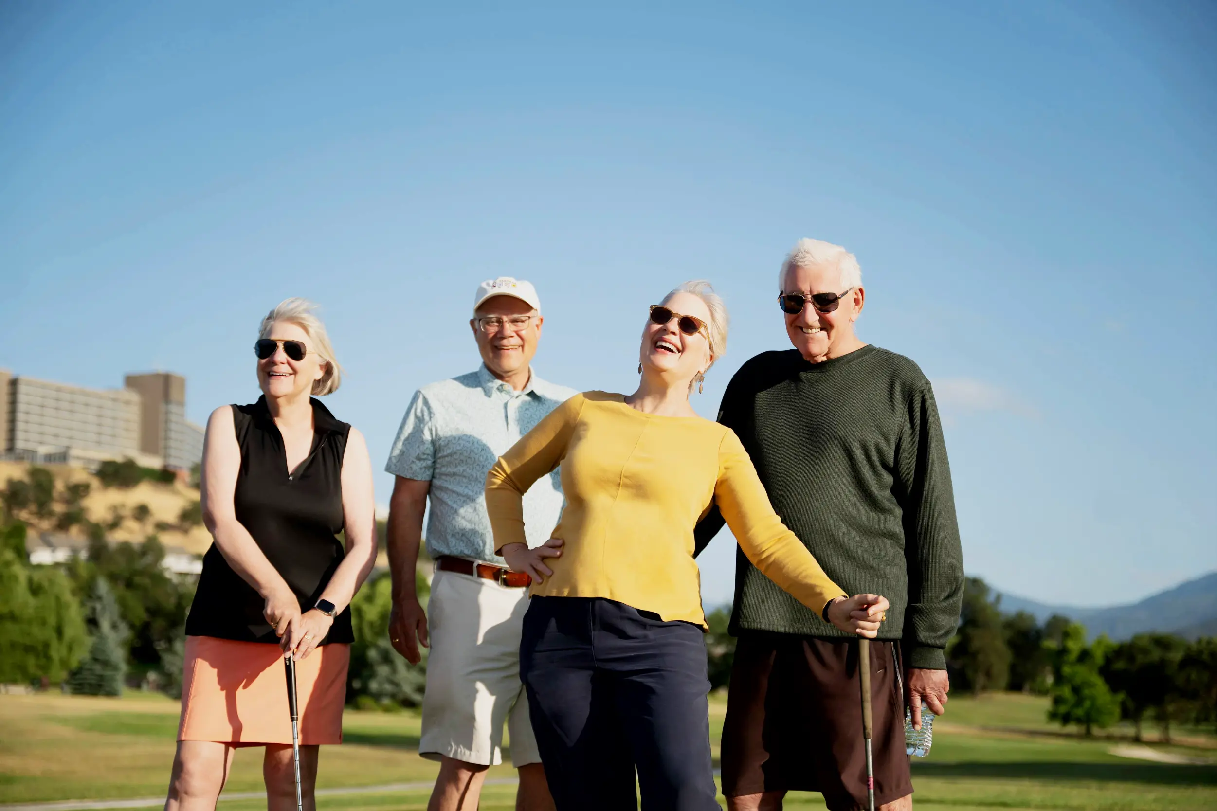 Four people on a golf course.